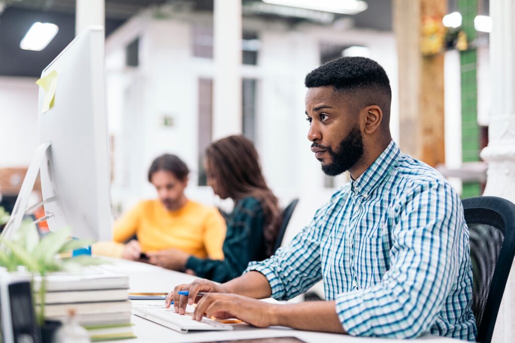 African Office Worker Using Computer